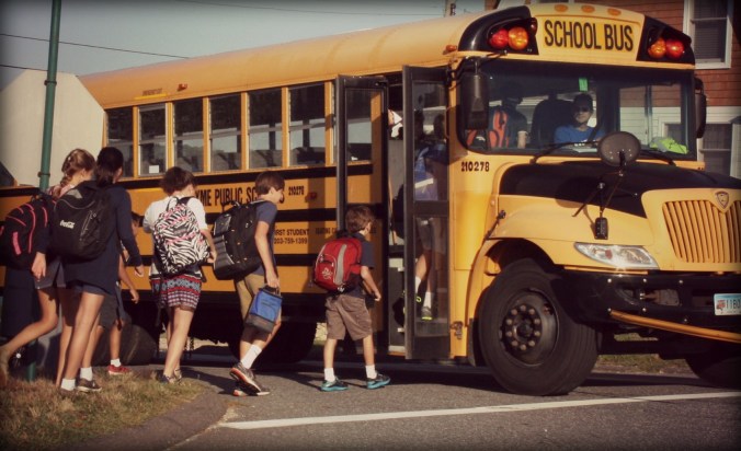 Y'all, look at how TINY he is next to the rest of these kids. (He's the tiny one with the red bulging backpack.) I'm pretty sure this is the college bus. And LOOK, the kid behind mine can't fit in his lunchbox either. See??